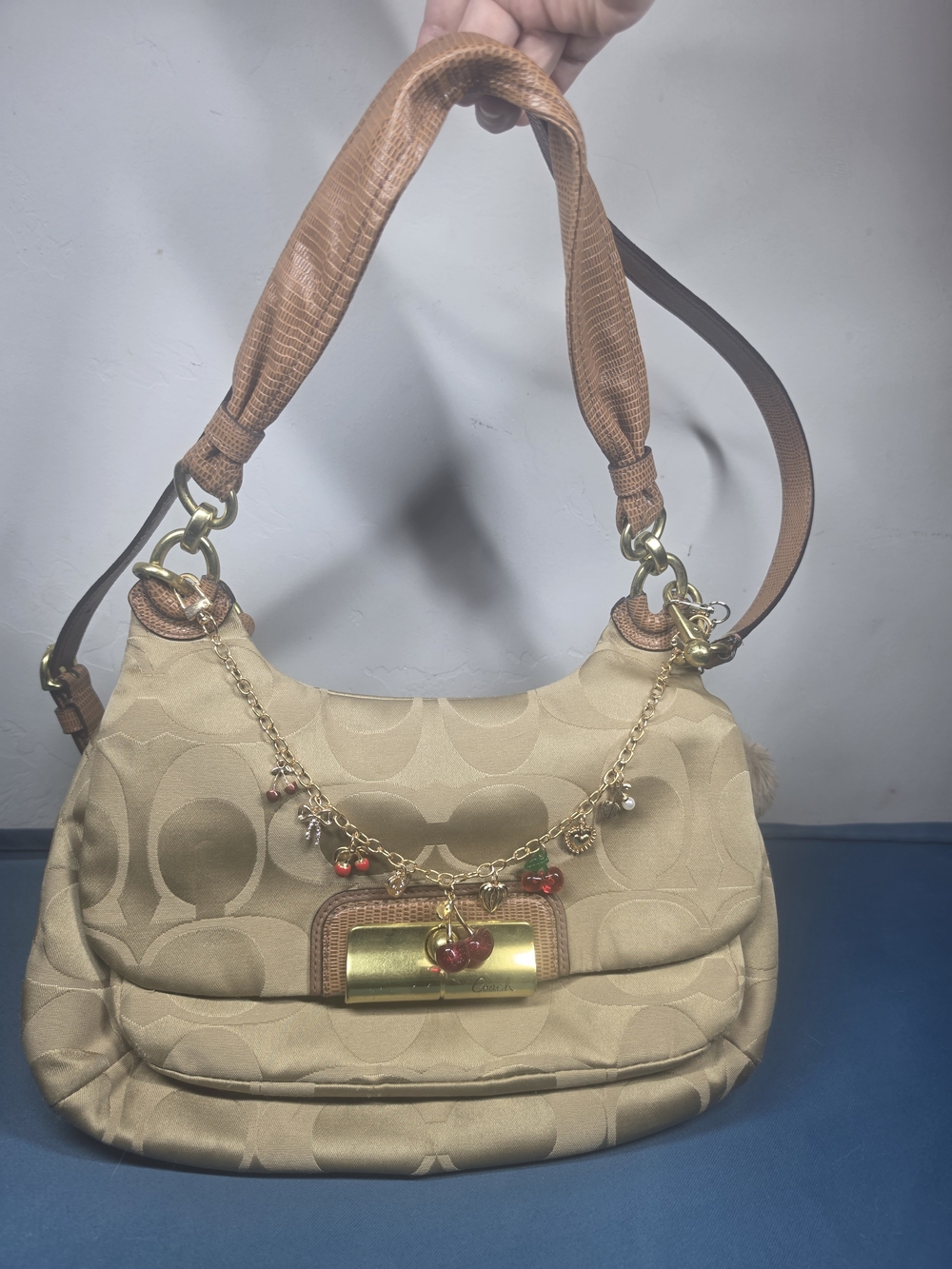 Coach Beige Signature Shoulder Bag with Gold Charm Chain and Red Accents